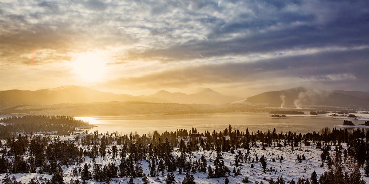 View of Dillon Reservoir with snow and sun rays