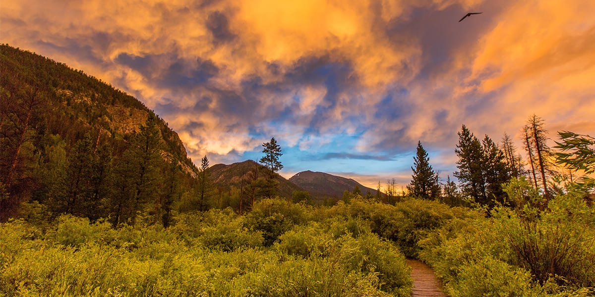 Rainbow lake trail boardwalk with colorful sky