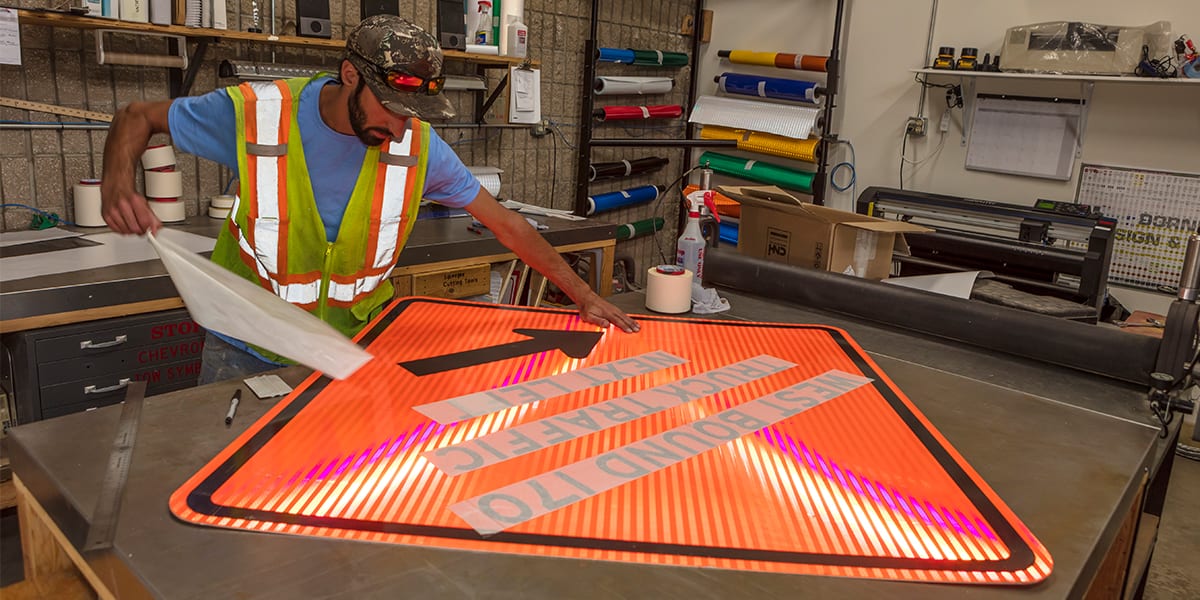 Public Works employee creating a sign in the sign shop