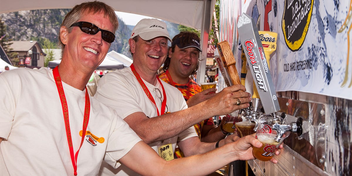 Volunteers pouring beer at the BBQ Challenge