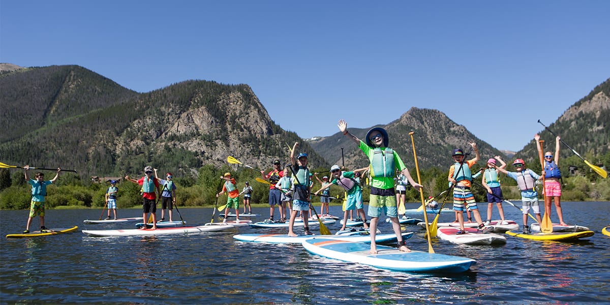 Kids on stand up paddle boards on Dillon Reservoir at H20 Camp