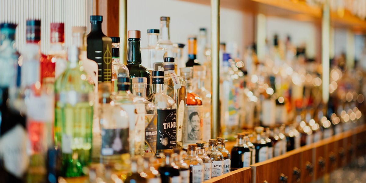 A bar shelf filled with liquor bottles