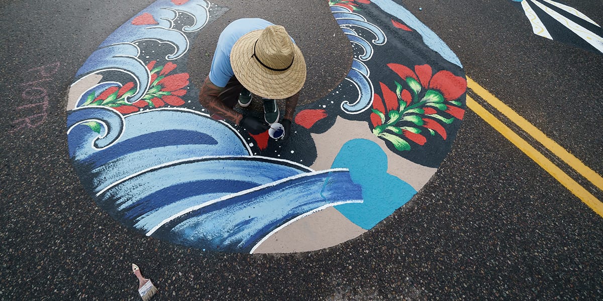 Artist working on the Black Lives Matter mural on Frisco Main Street in July 2020