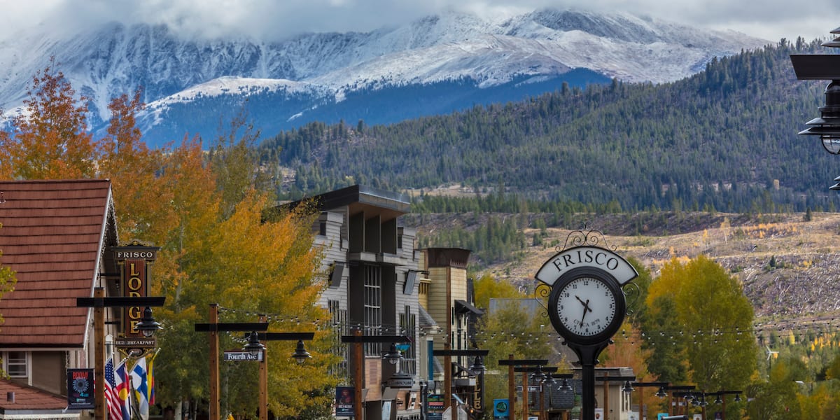 Frisco Clock on Main Street in the fall with snow on Greys and Torreys