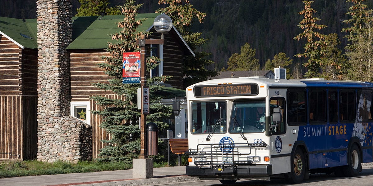 Summit Stage bus driving on Frisco Main Street with the words "Frisco Station" on the bus