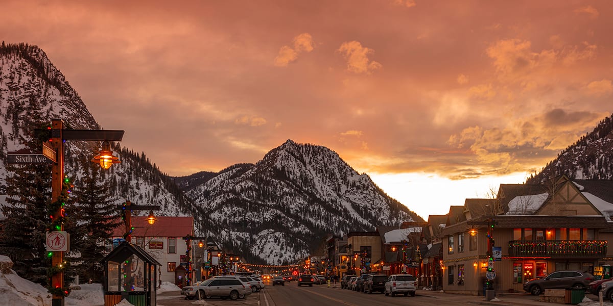 Frisco Main Street at dusk with holiday lights and snow