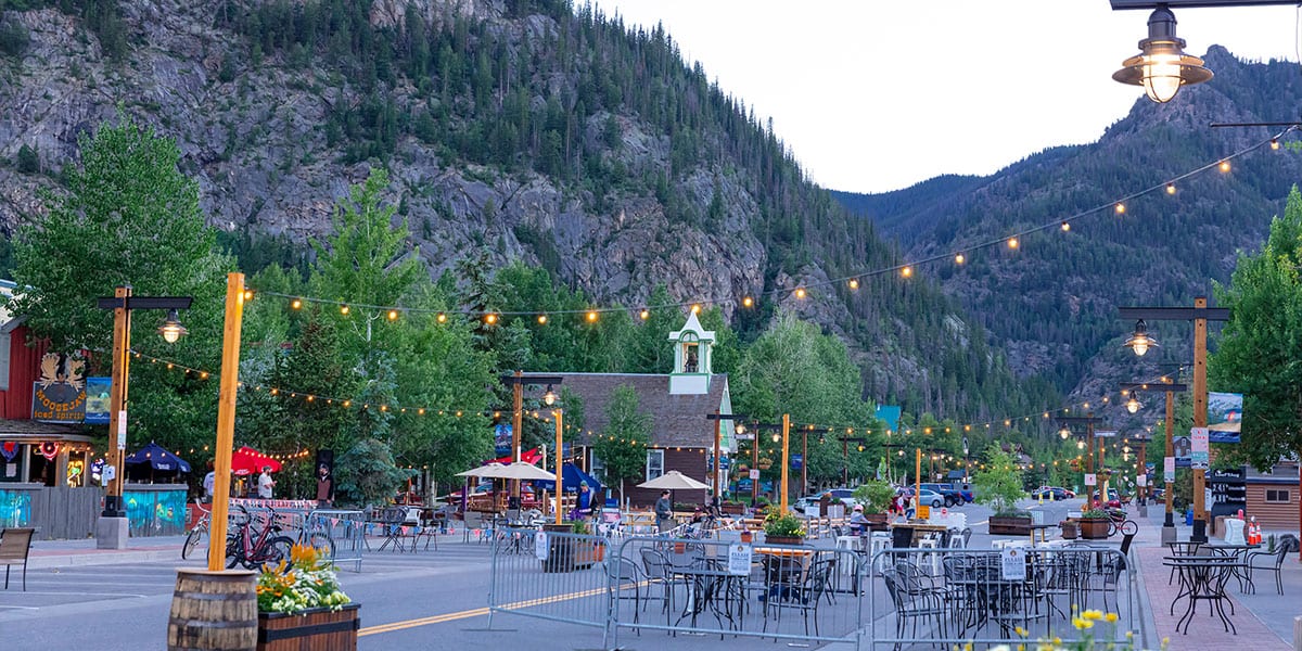 Twilight at the Frisco Promenade, people dining outdoors.