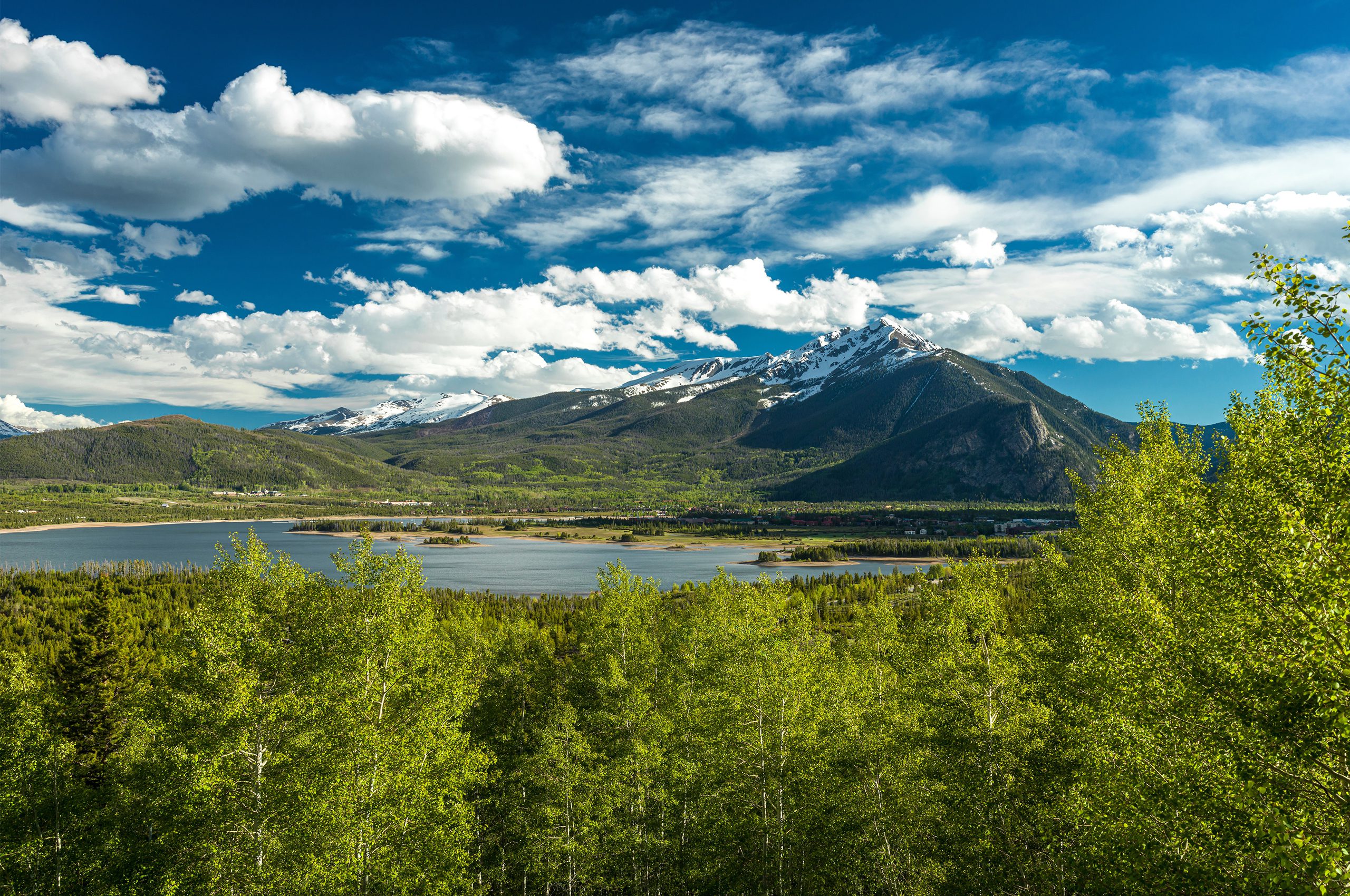 View of Peak One with snow and Dillon Reservoir in spring