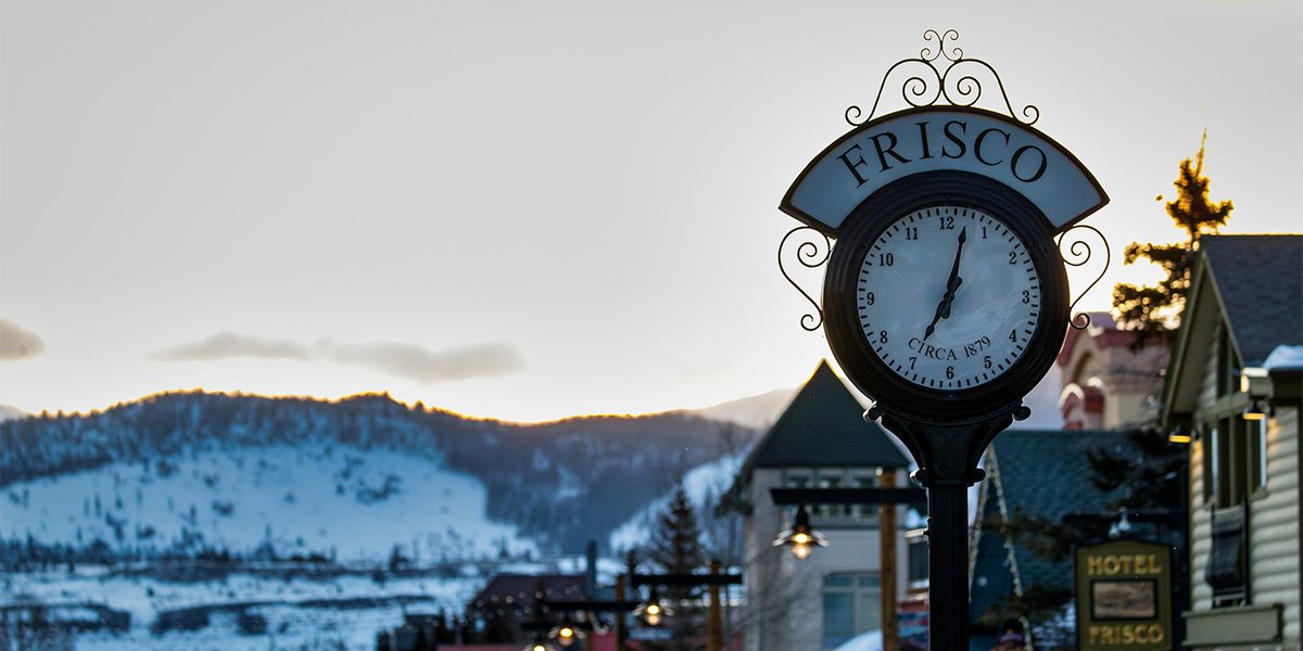 Closeup of Frisco Clock with a sunrise over a mountain in the background