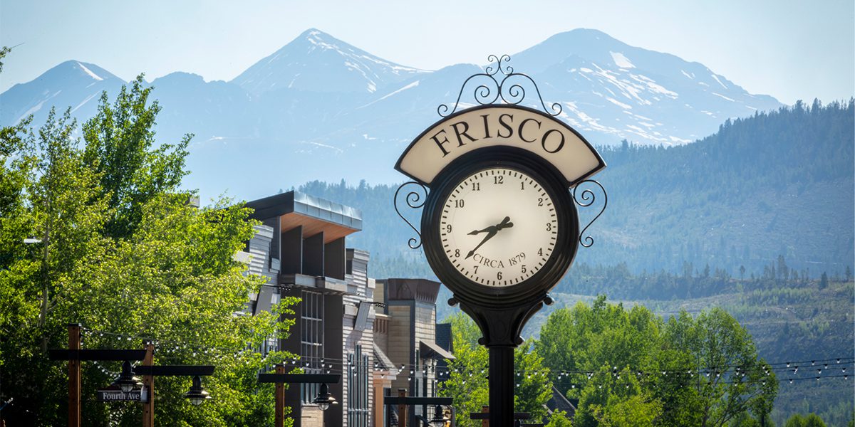 Frisco clock in the spring with green trees