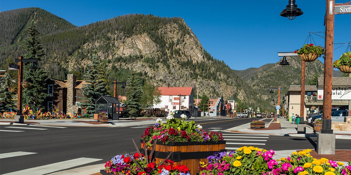 Main Street and Sixth Avenue with flower boxes and Mt. Royal in the background